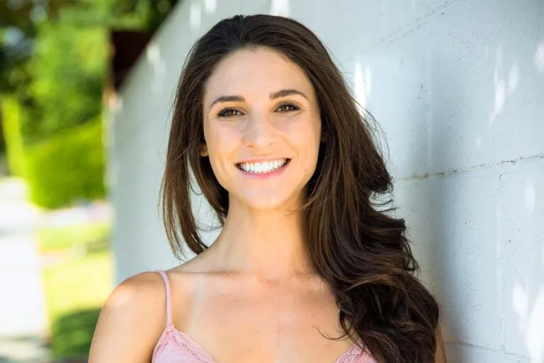 Woman with a bright, confident smile showcasing teeth whitening results in Los Angeles.