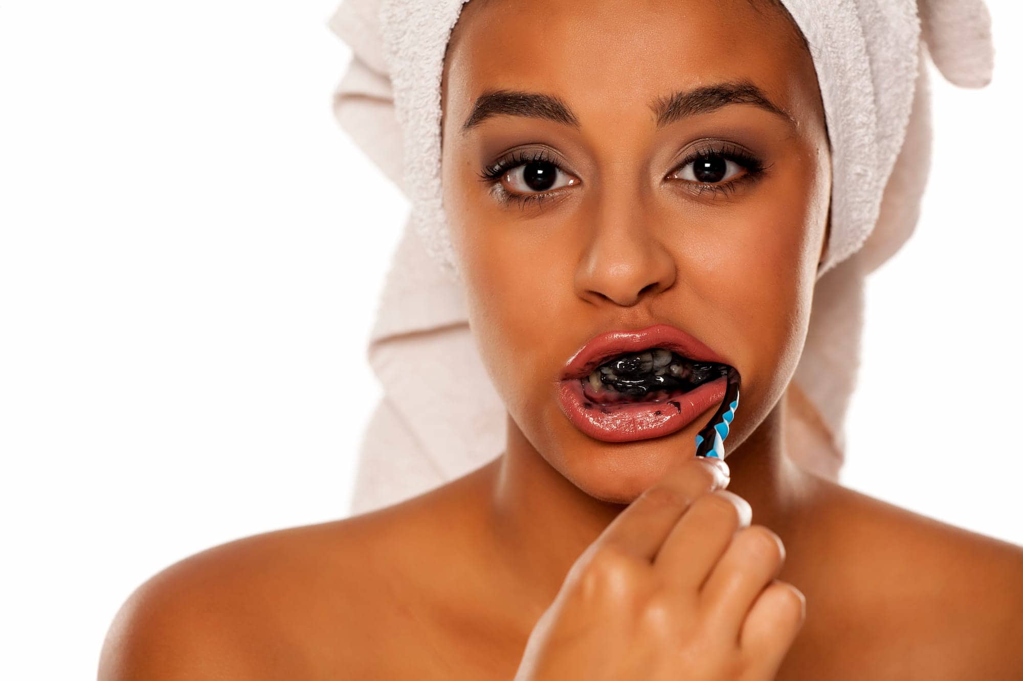 Woman wondering “Is charcoal toothpaste bad for your teeth?