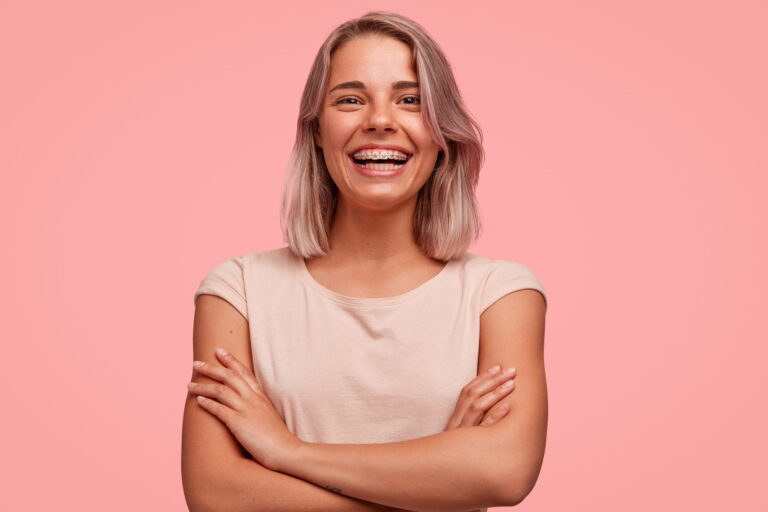 young woman wearing braces from orthodontist in Brentwood, ca