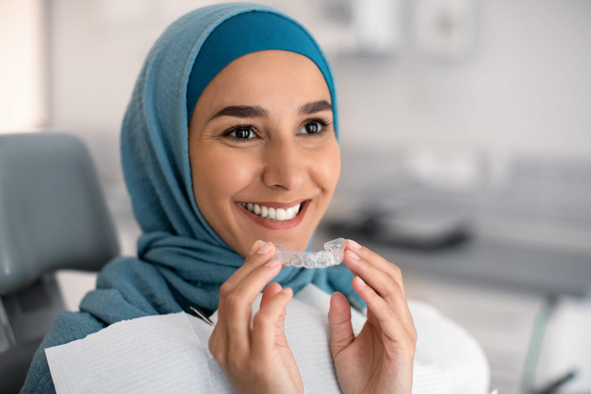 A woman with Invisalign retainer