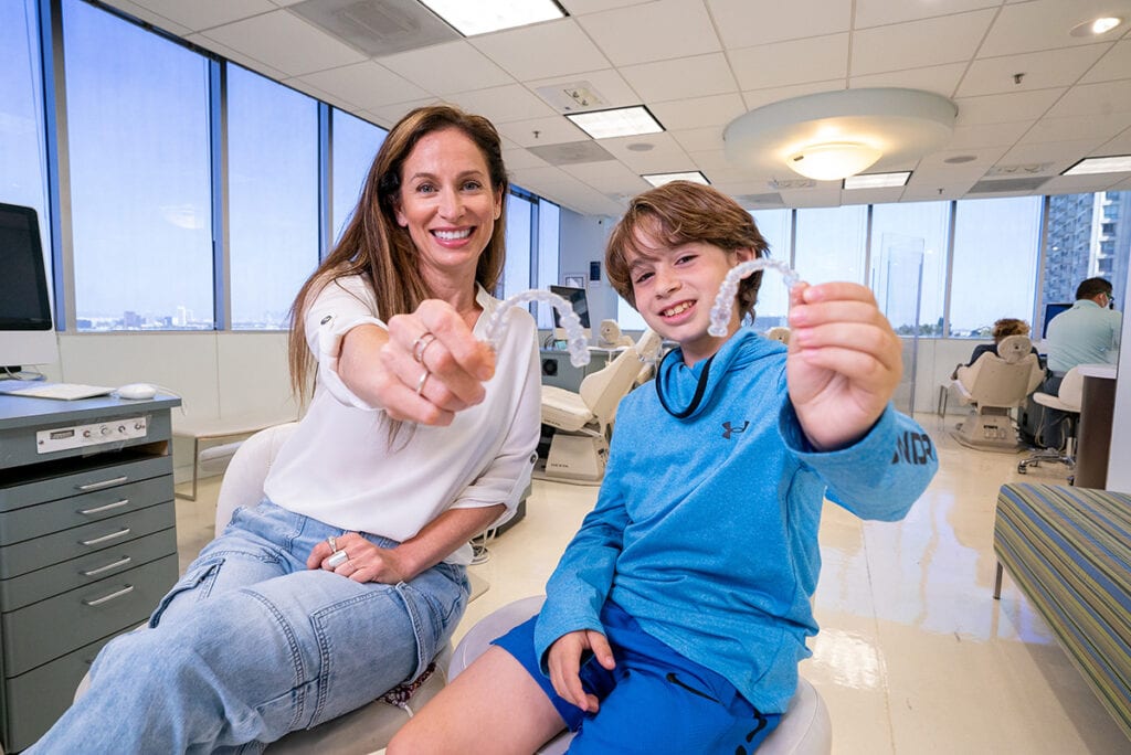 A mother and son show off their Invisalign aligners