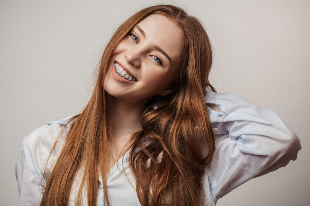 young woman smiling with ceramic braces