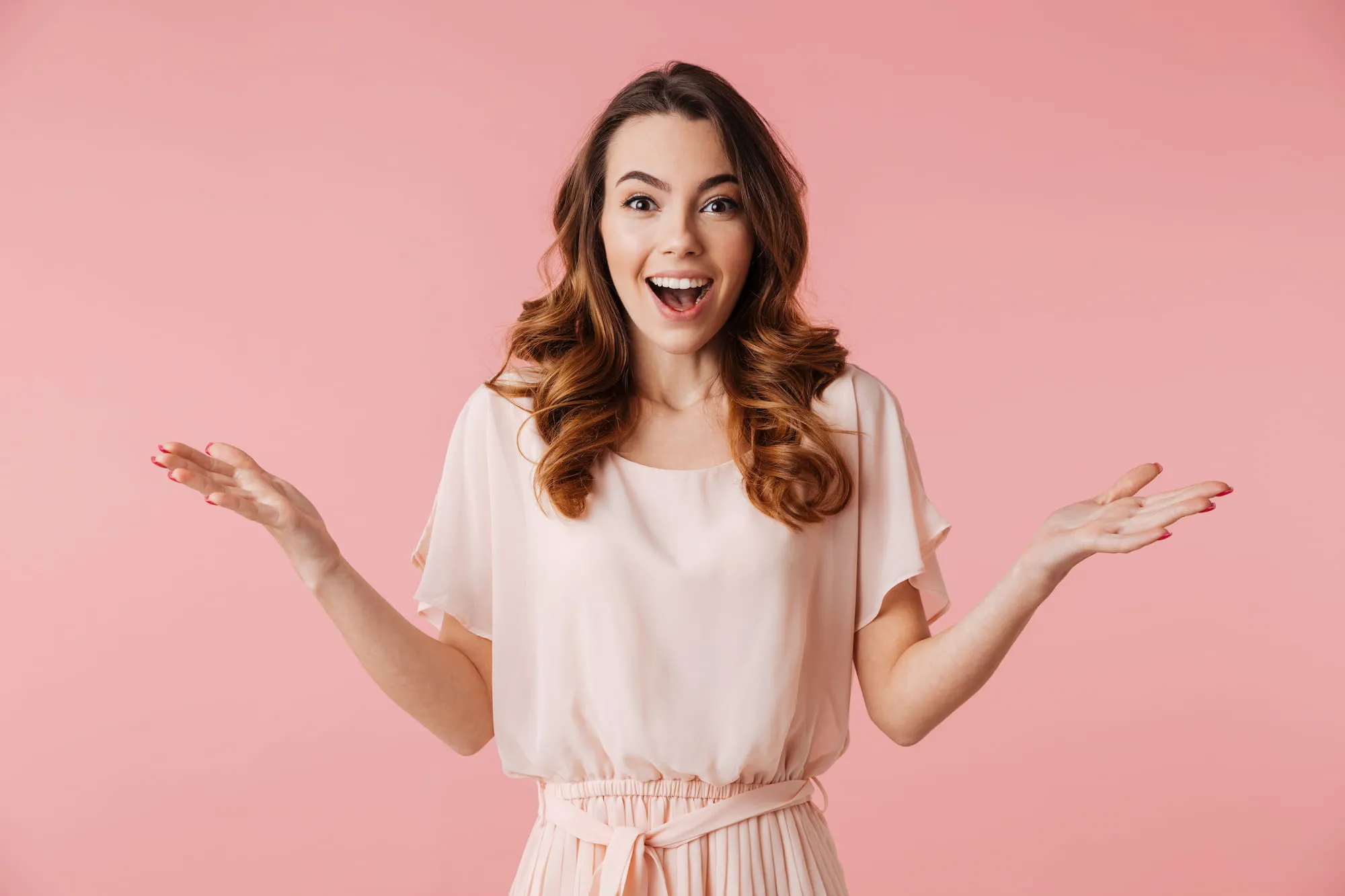 A woman shows off her gorgeous smile after receiving treatment from adult braces.