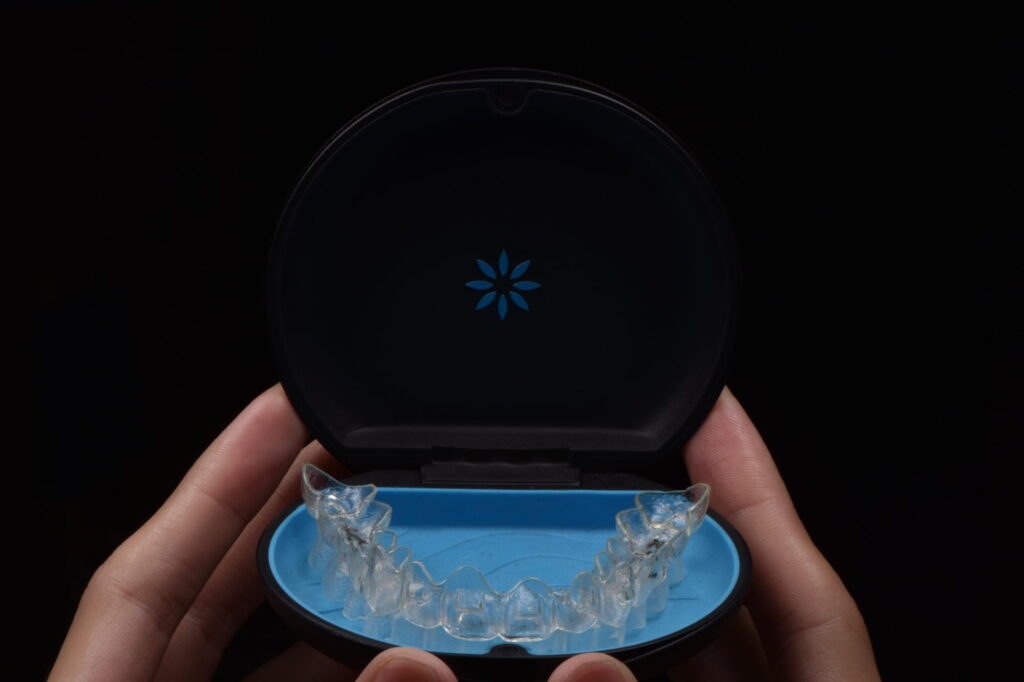Invisalign retainer and case on display at Beverly Hills Orthodontics