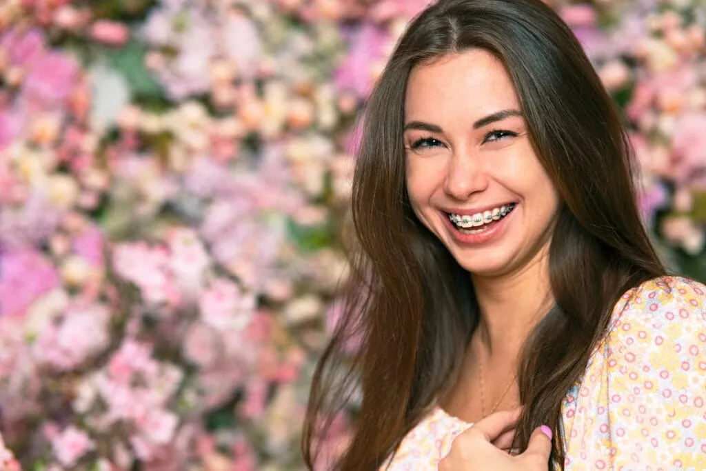 A woman with braces shows off her gorgeous smile.