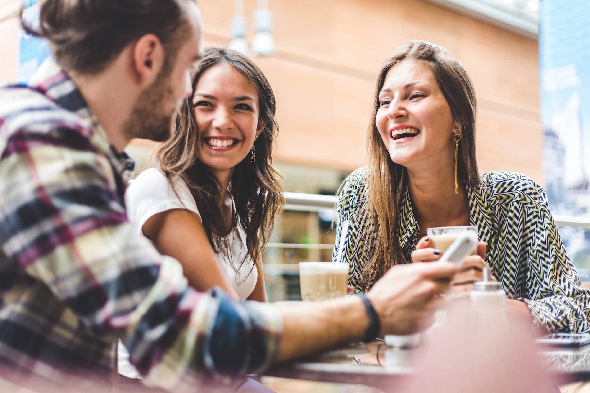 Woman wondering, “Can braces improve my speech?” while talking to friends