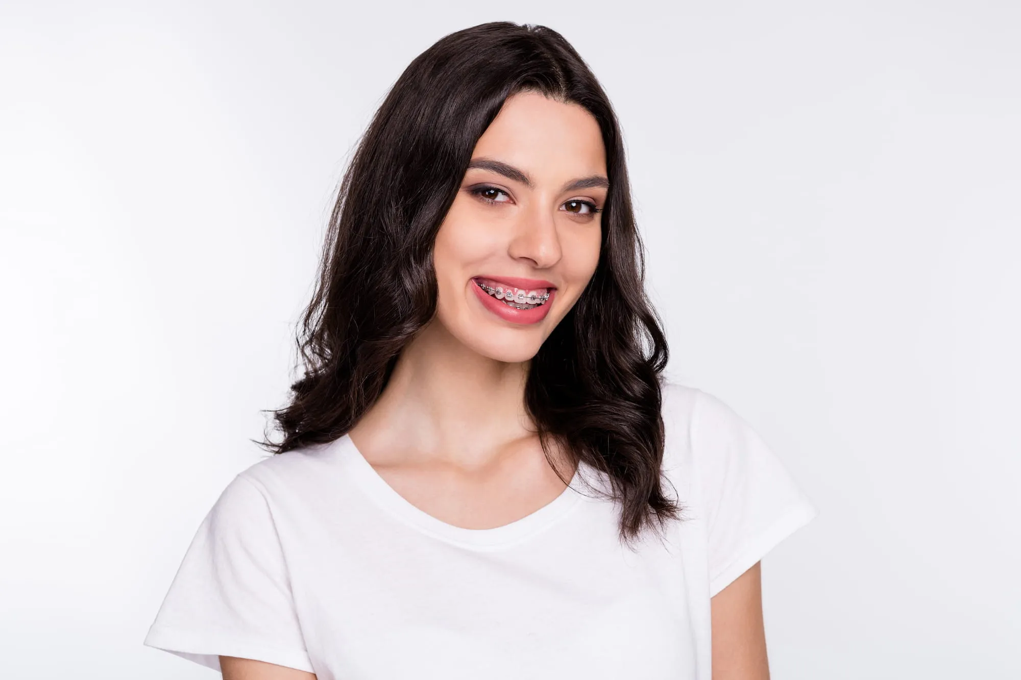 A young woman with braces shows off her soon to be dazzling smile.